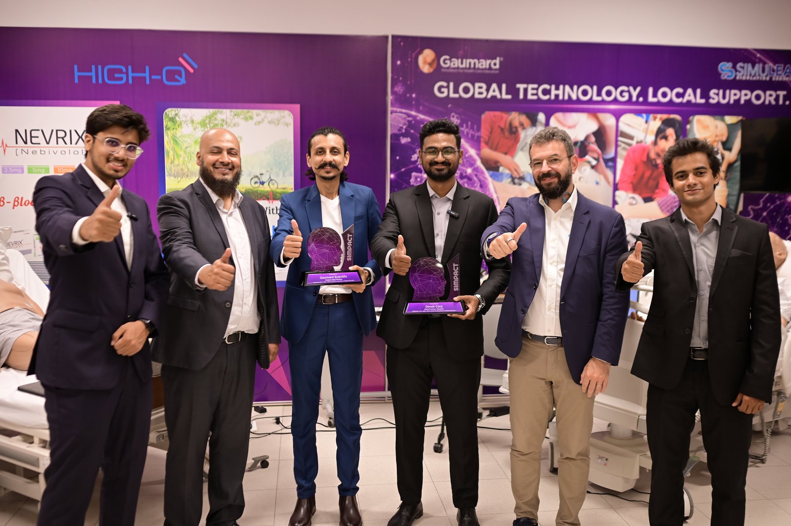 Deneb Corporation team receiving Gold Partner award at SIMPACT