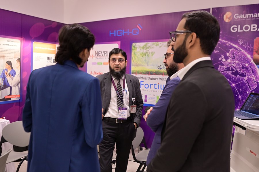 Deneb team discussing technology at SIMPACT 2026 booth